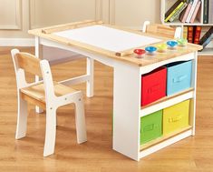 a child's wooden table and chair with colorful bins