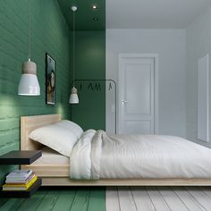 a bedroom with green walls and white bedding in the center, along with wooden flooring