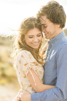 a young man and woman embracing each other