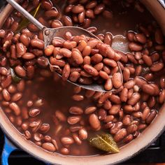 a pot filled with beans on top of a stove