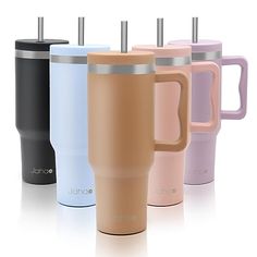 four different colored coffee cups with lids and straws in each cup, all lined up