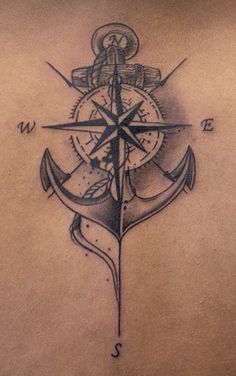 an anchor and compass tattoo on the back