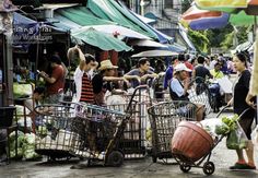 many people are shopping at an outdoor market