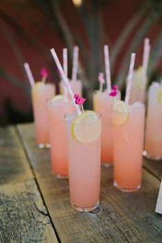 pink lemonade cocktails lined up on a wooden table