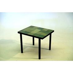 a green table with black legs on a white background