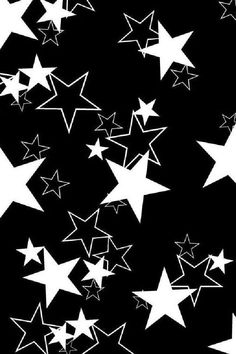 black and white stars are flying in the air, creating a pattern on a dark background