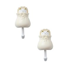 two white cat shaped lollipops sitting next to each other on a white background