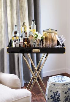 a bar cart filled with liquor bottles and glasses