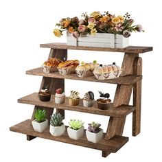 three tiered wooden shelf with cupcakes and flowers in them on white background