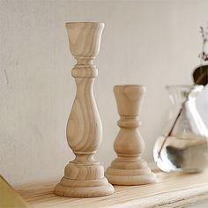 three wooden candlesticks sitting on top of a table