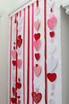 valentine's day decorations are hanging on the wall