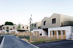 an empty parking lot with several houses in the background