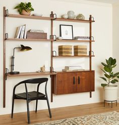 a room with a chair and shelves on the wall