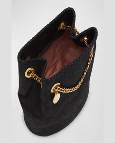 Stella McCartney "Falabella" bucket bag in vegan leather (polyurethane) and polyester     Sliding golden chain crossbody strap can be doubled     Drawstring closure     Interior, one slip pocket     Approx. 8.7"H x 12.4"W x 5"D    Spot clean    Made in Italy Pebbled Leather Bucket Bag With Gold-tone Hardware, Chic Black Bucket Bag With Gold-tone Hardware, Black Leather Bucket Bag With Gold-tone Hardware, Black Bucket Bag With Gold-tone Hardware, Stella Mccartney Bag Falabella, Falabella Bag, Circular Logo, Stella Mccartney Falabella, Suede Fashion