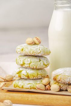 a stack of cookies sitting next to a bottle of milk