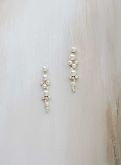 Pearls add a touch of sophistication to any look, and these clustered pearl drop earrings are no exception. Wear these lovely earrings on their own or pair with our matching 2428 necklace! Adorned portion measures approximately 3 1/4 inches long and 3/4 of an inch wide at its widest point Austrian pearls Finished with Bridal Earrings Silver And Pearl, Wedding Pearl Earrings Brides, Wedding Jewelry Ideas For Bride Pearls, Bride Pearl Earrings, Pearl Wedding Earrings Brides, Dainty Wedding Jewelry, Pearl Bride Jewelry, Vintage Earrings Wedding, Bride Jewelry Pearl