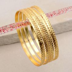 About item Item :-Brass Gold Plated Bangles Bangles size :- Chose from variation (Custom size accepted) Material  :- Brass Title:- 18k/14k Gold Stacking Bangle, Statement Gold Bangle, Gold Filled Bangle, Gold Bracelet, Bangle, Gold Filled Bracelet, women Gold  Bangles, Gold Raw Brass Cuff Bracelets, Bangles For Women, Valentine's day gift, Christmas day gift, Wedding Gifts, Anniversary Gift, Birthday Gifts Bangles, Stackable Bangles Description:- We accept all types of custom & personalized order. Please send us a message if you are interested in a custom creation. ♥ Is brass harmful for skin? As such, if you're wearing a brass Silver, Copper. it is most likely to leave a green mark on your skin when you sweat or wash your hands. This is generally not harmful or painful (it is just oxidati Gold Hoop Bangle In Metal, Women Gold Bangles, Bracelet Women Gold, Bracelet Bangle Gold, Gold Bracelet Bangle, Brass Cuff Bracelet, Bangles Gold, Stackable Bangles, The Bangles