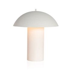 the mushroom lamp is white and has a light on it