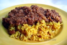 a yellow plate topped with rice and beans