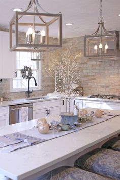 a kitchen with white cabinets and an island