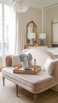 a bed room with a neatly made bed and a tray on top of the bed