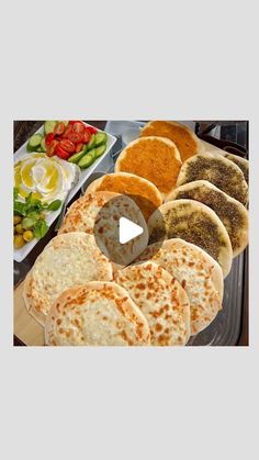 the meal is prepared and ready to be eaten on the buffet table, including pita breads