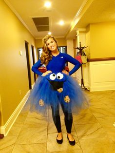 a woman wearing a blue dress with eyes on it