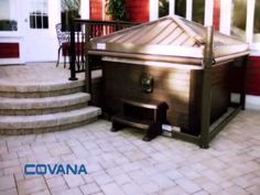 a hot tub sitting on top of a patio next to steps