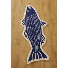 a blue fish rug is on the floor