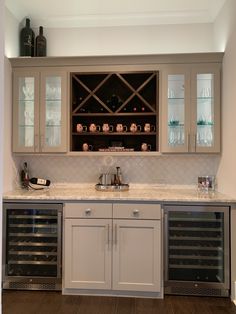 a kitchen with cabinets and wine bottles in it