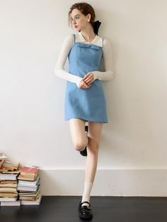 Casual and lovely mood dress in ocean blue color. Featuring the suspender shoulder straps design with button at back, ribbon at front, and the slim silhouette and mini length. The ruffle trim at hem is also accentuated. Layer with t-shirts, blouse, or cardigans to create lovely looks. - Deep squared neckline and suspender shoulder straps- Shoulder straps with white button closure at back- Big ribbon detail at neckline- Laced ruffle trim at hem- Zipper closure detail in white color- Slim silhouette and mini length Blue Mini Dress With Tie And Ruffled Straps, Blue Mini Dress With Ruffled Adjustable Straps, Light Blue Sleeveless Mini Dress With Adjustable Straps, Blue Mini Dress With Adjustable Ruffled Straps, Light Blue Mini Length Dress With Adjustable Straps, Blue Mini Dress With Adjustable Straps, Chic Blue Mini Dress With Ruffled Straps, Casual Blue Mini Dress With Straps, Blue Casual Suspender Dress