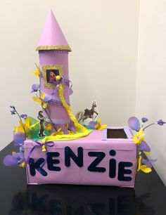 there is a cake made to look like a princess on top of a box with the name kenzie