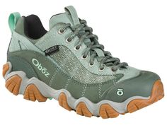 a women's gray and green sneaker with laces on the outstep