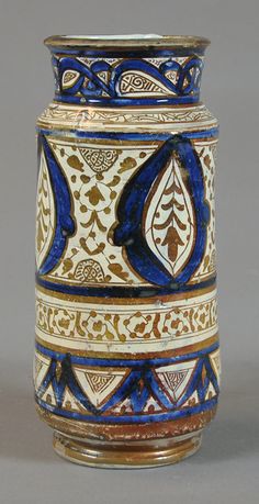 a blue and white vase sitting on top of a table