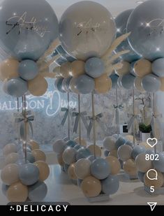 balloons are on display in front of a wall with the words congratulations written on them