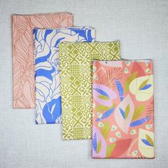 four pieces of fabric with different designs on them, all in various colors and patterns