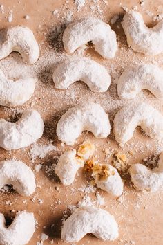 powdered doughnuts are on the table and scattered around them