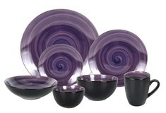 a purple and black dinnerware set with matching cups