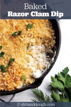 baked razor clam dip in a cast iron skillet with parsley on the side