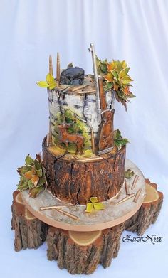 there is a cake made to look like a tree stump with leaves and branches on it