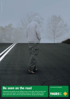 a man walking down the middle of an empty road