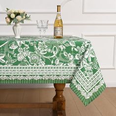 a green table cloth with white flowers on it