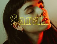 a woman with her eyes closed and the word sarah in yellow letters behind her