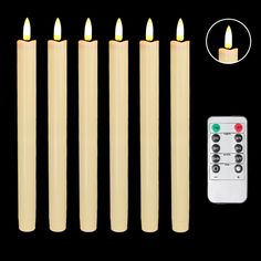 six candles with remote controls on black background