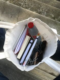 a white bag filled with books and other items