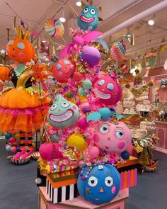 an assortment of brightly colored stuffed animals on display