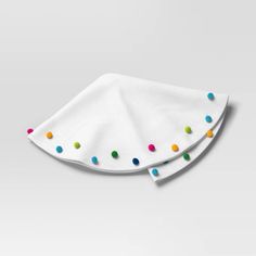 two white napkins with multicolored dots on them