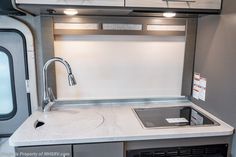 the kitchen sink is built into the side of an rv with stainless steel faucet