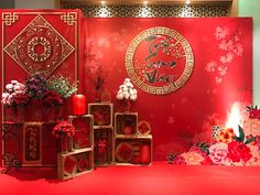 a red room with flowers and decorations on the wall