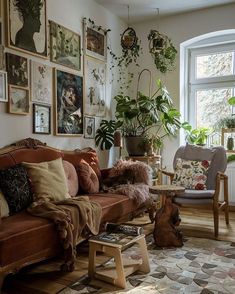 a living room filled with furniture and lots of plants